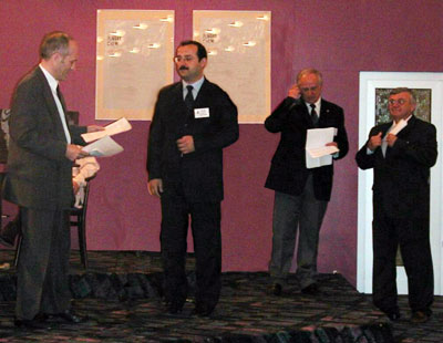 Dr. Ahmet K. Karabulut (centre of the scene) receives the Otto Zietzschmann Prize 2001 from 
							Prof. P. Simoens, President of the Board of Trustees of the Otto Zietzschmann Prize